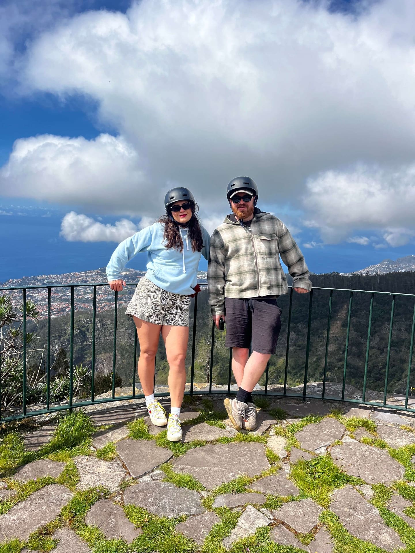 Couple posing at Madeira viewpoint with Funchal city in the background