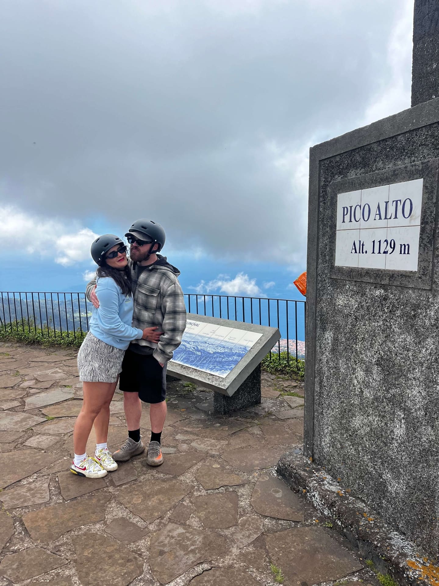 Couple hugging at Pico Alto viewpoint at 1129m altitude in Madeira
