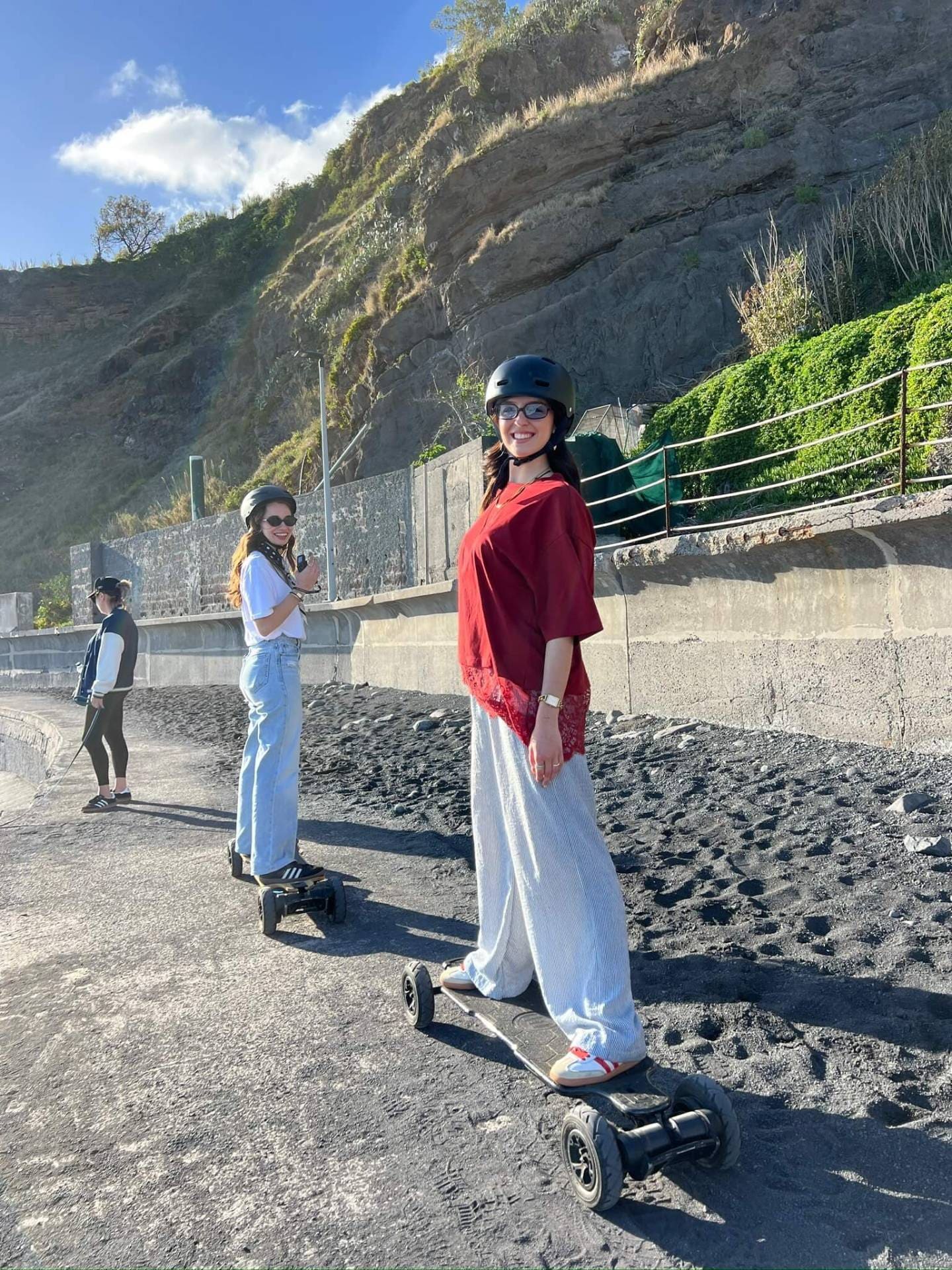 Two riders on electric mountainboards at Praia Formosa beach in Madeira