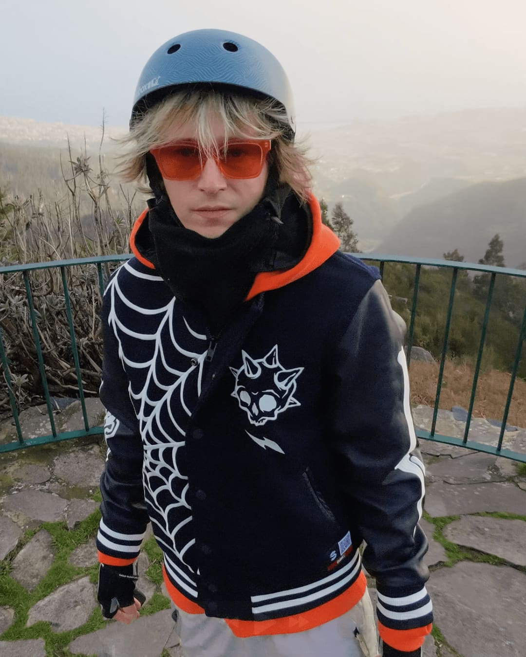 Rider portrait with helmet and orange shades at a Madeira mountain viewpoint