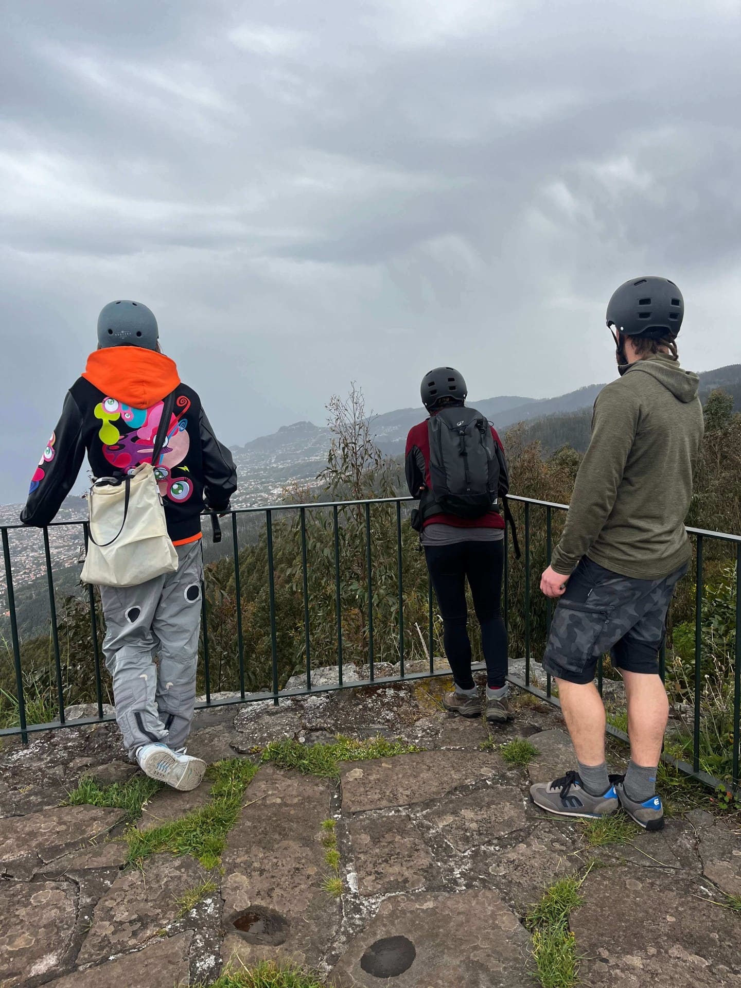 Three riders looking over Funchal from a mountain miradouro