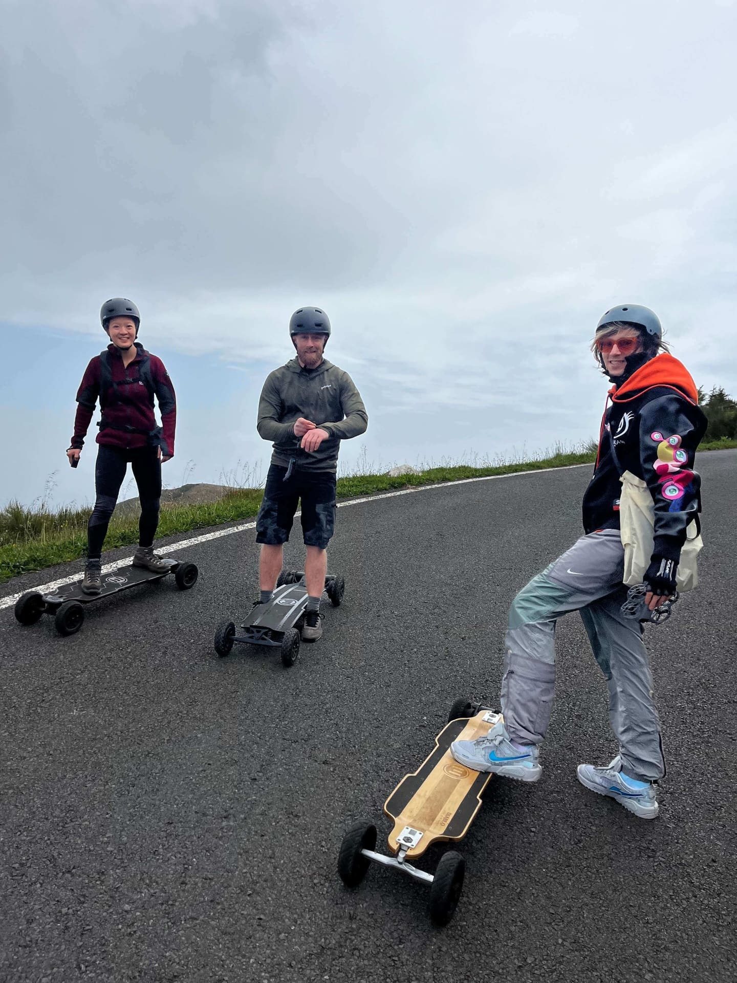 Three riders on electric mountainboards on a Madeira mountain road